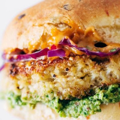 Spicy Cauliflower Burger held by hand.