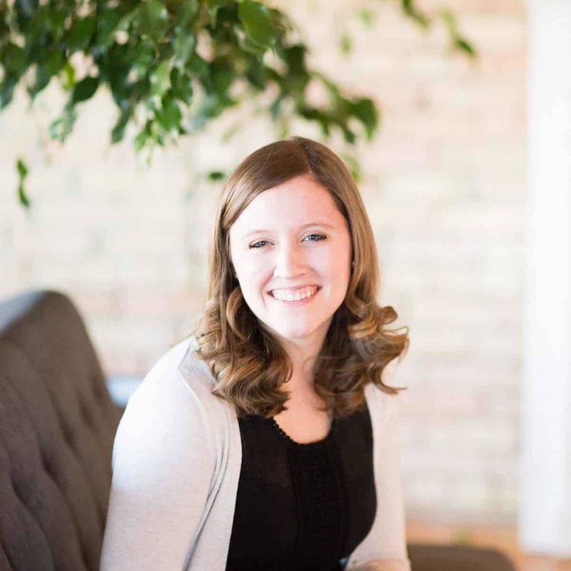 Jenna sitting on a couch in the studio.
