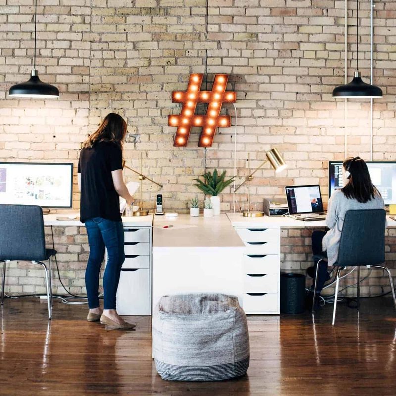 Jenna and Alana working at their desks side by side.