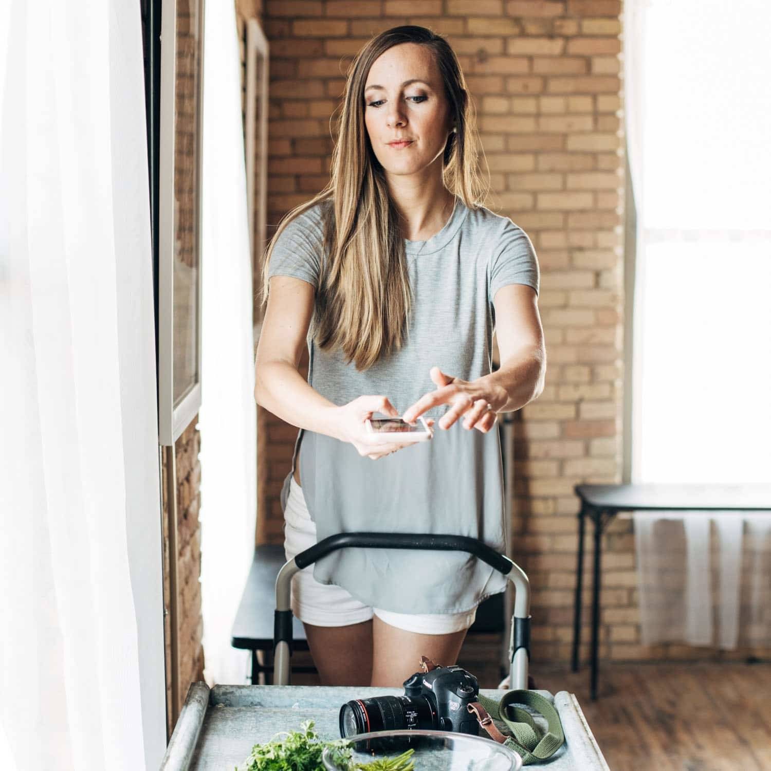 Woman taking a photo with an iphone.